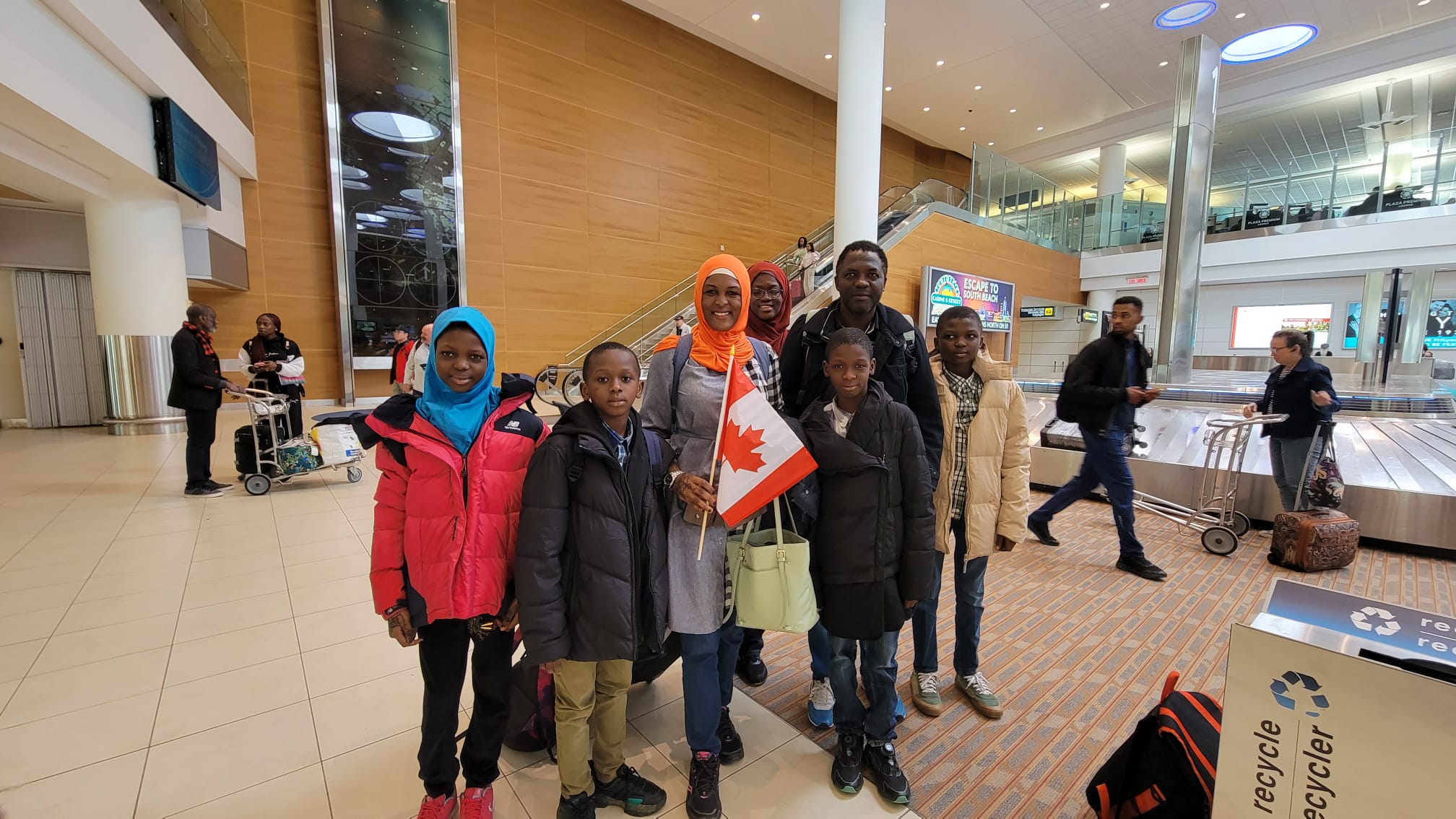 A happy family of 7 starting their new journey in Canada, representing successful immigrant entrepreneurship